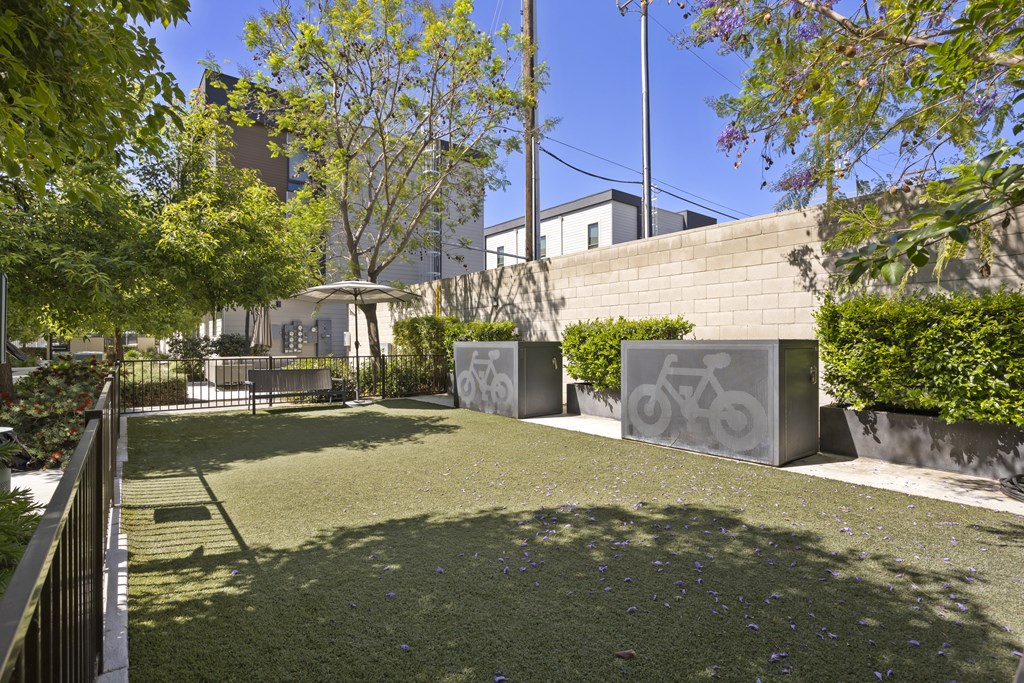A park with a bicycle symbol on a wall.